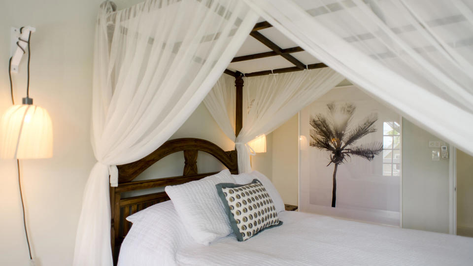 A private four-poster bedroom at Little Good Harbour, Barbados